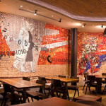 "Coming to the city", 2010-2011. Collaboration to the project of Spier Architectural Arts school (South Africa), on a drawing by Clive Van den Berg. Installed at Nando's restaurant, Kings Cross, Londra. 50 mq